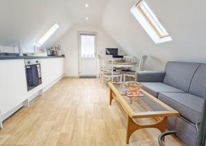 a living room with a couch and a table at Carthagena, Birdham in Chichester