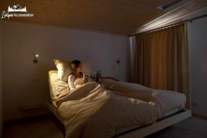 A bed or beds in a room at Appartamenti Green by Livigno Accomodation