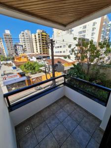 a balcony with a view of a city at Apartamento Praia do Morro com Churrasqueira, Cozinha Gourmet e Wifi in Guarapari