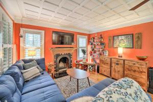 ein Wohnzimmer mit einem blauen Sofa und einem Kamin in der Unterkunft Cozy Wooded Retreat 2 Mi to Dtwn Brevard! in Brevard