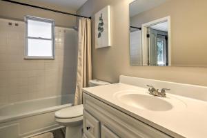 a bathroom with a sink and a toilet and a mirror at Scenic Conifer Getaway with Game Room and Hot Tub! in Conifer +32 photos