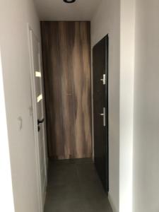 a hallway with two elevators and a door in a room at Apartamenty Platinex 6 in Krakow