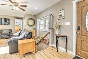 a living room with a couch and a clock on the wall at Peaceful and Secluded Knoxville Retreat with Deck in Knoxville