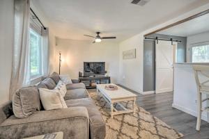 a living room with a couch and a table at San Marcos Cottage with Large Private Backyard! in San Marcos