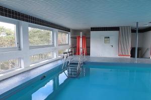 a swimming pool with a ladder in the middle of it at Carpe Diem Carpe Diem Appartement 109 in Niendorf