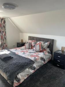 a bedroom with a bed and two night stands at The Steading with 7 Seater Hot Tub Aberdeenshire in Banff