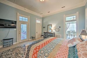 a bedroom with a large bed and a television at Renovated Carnegie Cottage - Walk to Dtwn! in Winnsboro