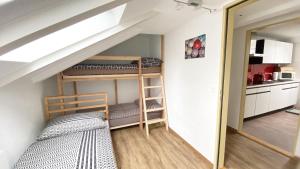 a room with a bunk bed and a kitchen at Holiday Apartments Falke in Brienz