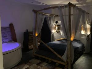 a bedroom with a canopy bed and a bath tub at Desirad in La Clisse +67 photos