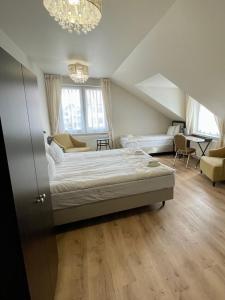 a bedroom with a bed and a living room at Zajazd Arkadia in Siemiatycze