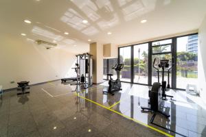 a gym with treadmills and cardio equipment in a building at Primera línea de mar con piscina, gimnasio y parking 2 hab y 2 baños in Villajoyosa