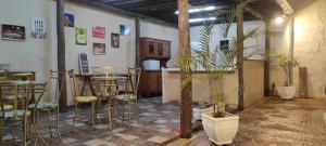 a room with a bar and stools and plants at Belo Quinto Styles in Brotas