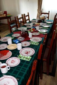 a long table with plates of food on it at Vadászház Karád in Karád