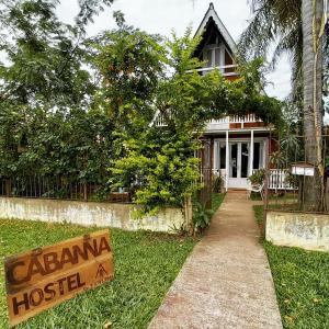 a house with a sign in front of it at Cabanna Hostel in Candelária