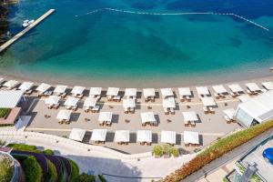 an aerial view of a beach with chairs and umbrellas at Dukley Hotel & Resort in Budva