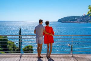 a man and a woman looking out at the water at Dukley Hotel & Resort in Budva