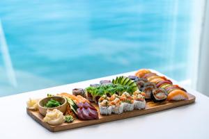 a platter of sushi and vegetables on a table at Dukley Hotel & Resort in Budva