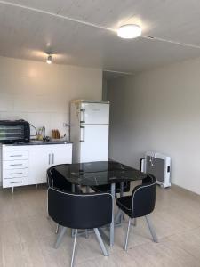 a kitchen with a table and chairs in a room at Cabañas Campo Quijano - Desértico in Salta