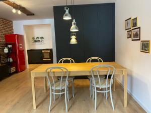 a dining room with a wooden table and chairs at Green Corner of Bovec - Apartment Bovec in Bovec