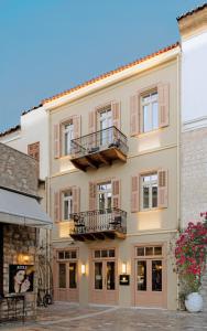 un gran edificio con 2 balcones. en Castellano Hotel & Suites, en Nauplia