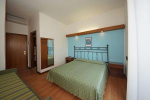 Postel nebo postele na pokoji v ubytování Hotel President