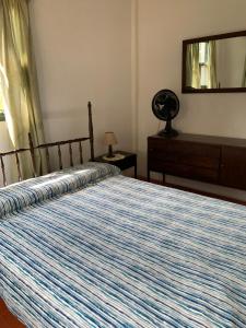 a bedroom with a bed and a dresser and a mirror at Tranquilo entorno campestre in Treinta y Tres