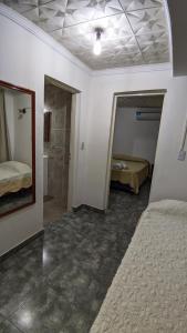 a room with two beds and a walk in shower at Apart termas in Termas de Río Hondo