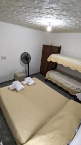 a room with two beds and a fan at Apart termas in Termas de Río Hondo