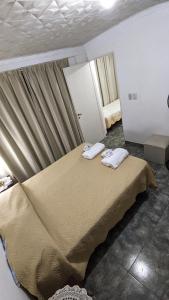 a bedroom with a bed with two towels on it at Apart termas in Termas de Río Hondo
