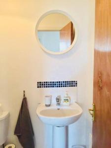 a bathroom with a sink and a mirror at Flat 7 EIA House in Belfast
