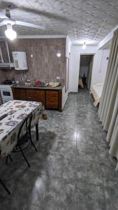 a kitchen with a table in the middle of a room at Apart termas in Termas de Río Hondo