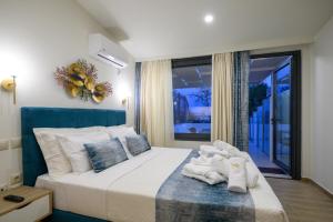a bedroom with a bed with towels on it at Kalypso Apartments in Kalamata