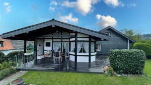 a screened in porch with a deck at Wohnen im bergischen Fachwerk in Overath