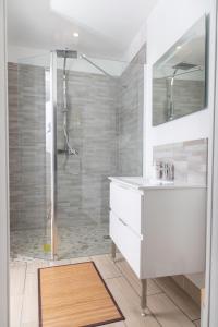 y baño con lavabo blanco y ducha. en Appartement 70m2 hyper centre avec baignoire balnéo, en La Flèche
