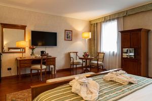 Postel nebo postele na pokoji v ubytování Hotel Roxy Plaza