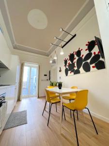 a kitchen and dining room with a table and chairs at ERASMO 19 Luxury Home in Catania