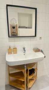 a bathroom with a white sink and a mirror at KAINZLEITENHOF am Traunsee in Nachdemsee +47 photos