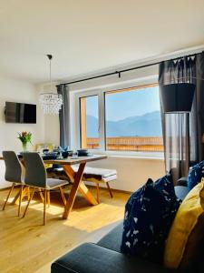 a living room with a table and a large window at KAINZLEITENHOF in Nachdemsee +53 photos