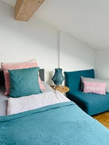 a bedroom with a bed and a blue couch at KAINZLEITENHOF am Traunsee in Nachdemsee