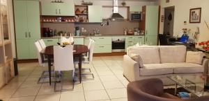 a kitchen and living room with a table and a couch at LE PATIO in Canet-en-Roussillon