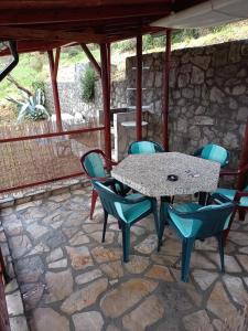 a table and chairs on a stone patio at Apartment Jankovic in Tivat