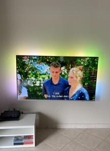 a flat screen tv hanging on a wall at Familie appartement hartje Knokke met optie parking in Knokke-Heist