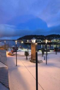 a clock tower in the middle of a square with lights at Seaside Apartment in Oban