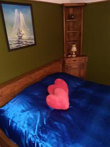 a red heart pillow on a bed in a bedroom at Yacht Club in Liepāja