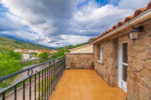 a balcony of a house with a view at Casa Rural La Nava del Concejo in Navaconcejo