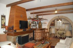 a living room with a fireplace and a kitchen at Villa sul Mare in Chalkida