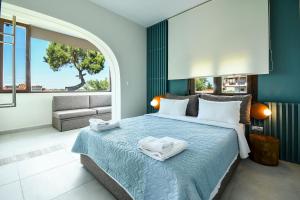 a bedroom with a bed with two towels on it at Zinozis Beach Apartments in Vourvourou