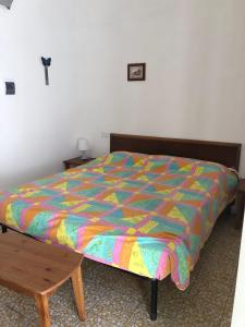 a bed with a colorful comforter in a bedroom at Rocca Sul Mare Hotel in Vieste