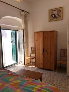 a bedroom with a bed and a sliding glass door at Rocca Sul Mare Hotel in Vieste