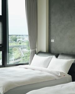 En eller flere senger på et rom på 宜蘭-讀好民宿 Read Nice House B&B 電梯民宿